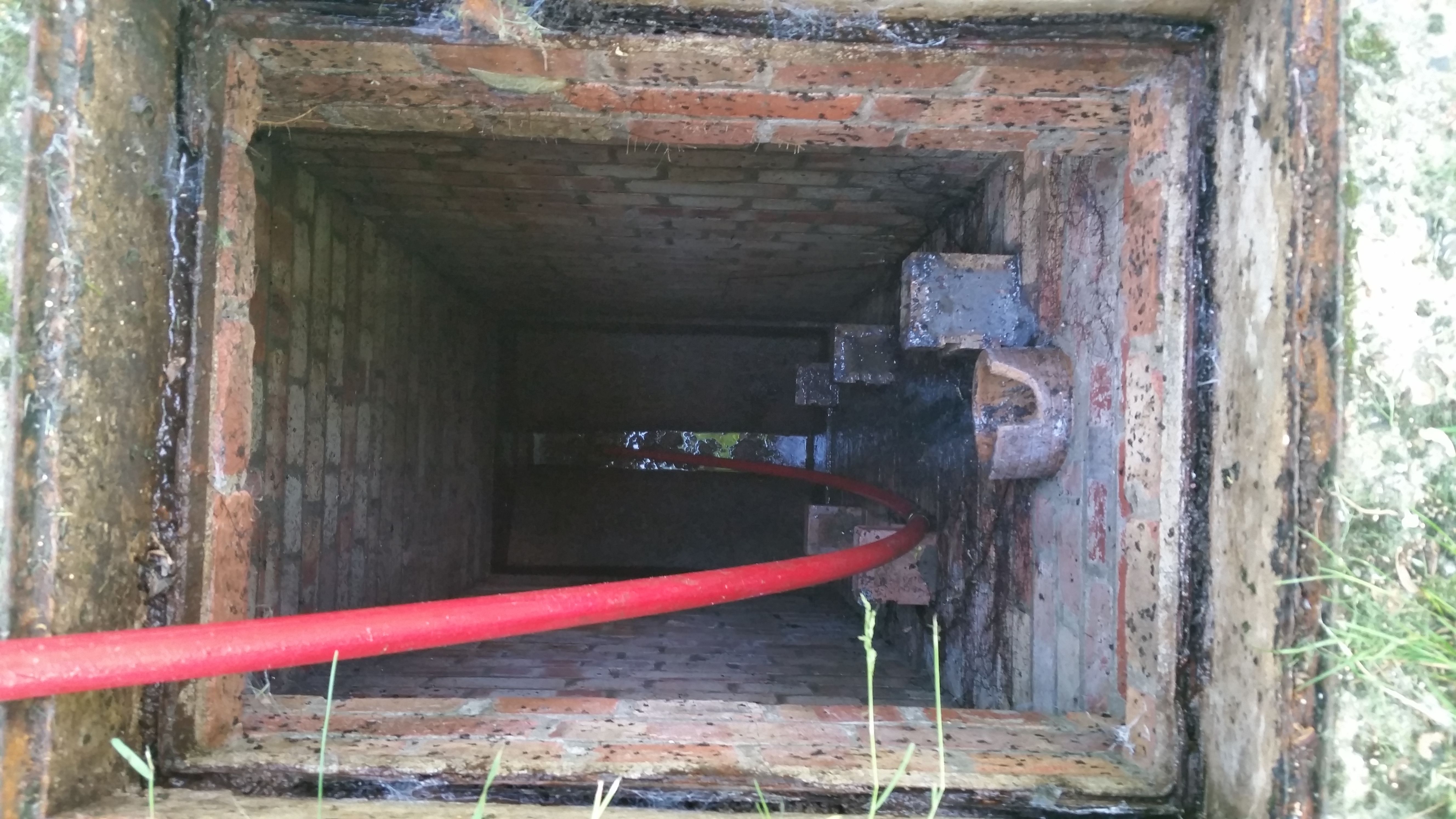 Drain being cleared using rods